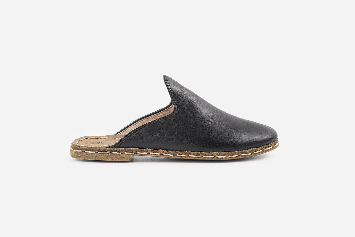 Women's slippers in Midnight Noir leather, handmade for a deep, luxurious black color and refined style.