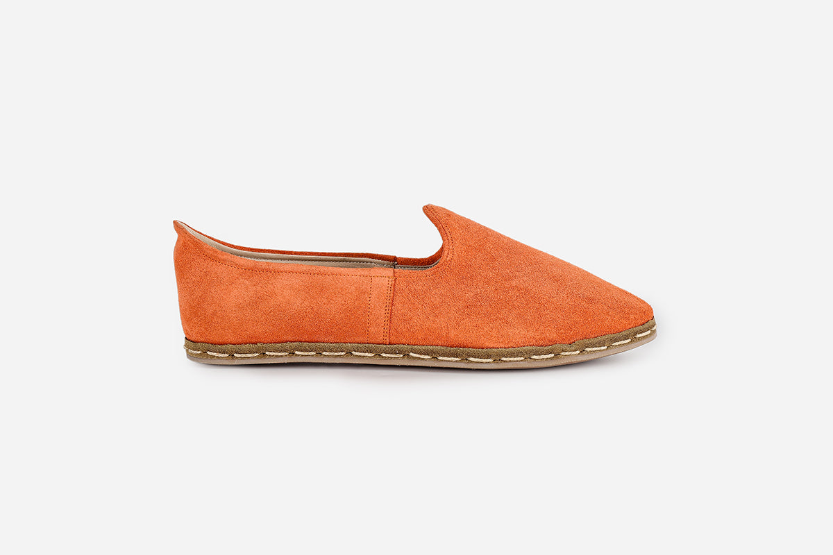 Women's loafers in Saffron suede, handmade for a vibrant, warm color and elegant, detailed design.