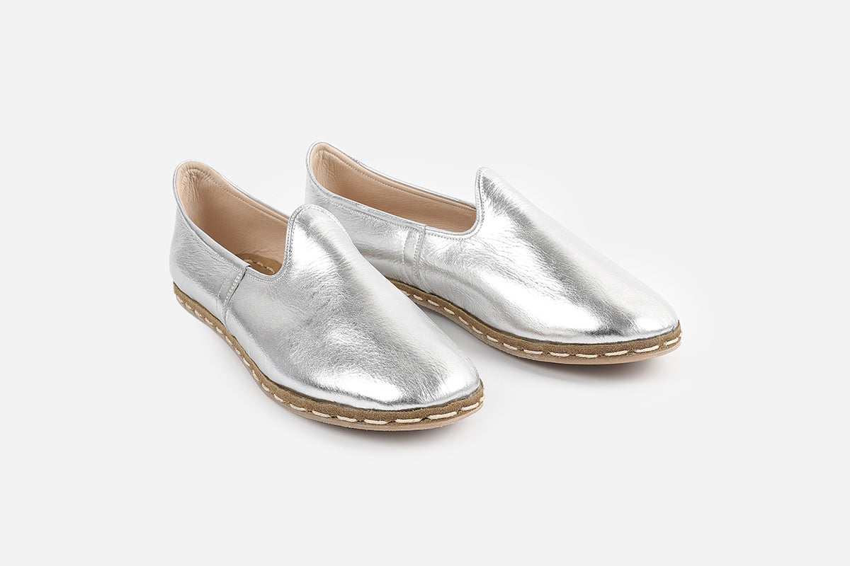 Elegant handmade leather loafers in Silver Frost for women, featuring a shimmering silver hue and sophisticated craftsmanship.