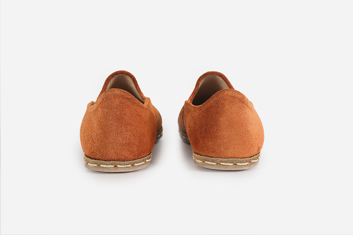 Stylish women's loafers in Sunset Orange suede, offering a unique, handmade look with a radiant, sunset-inspired color.