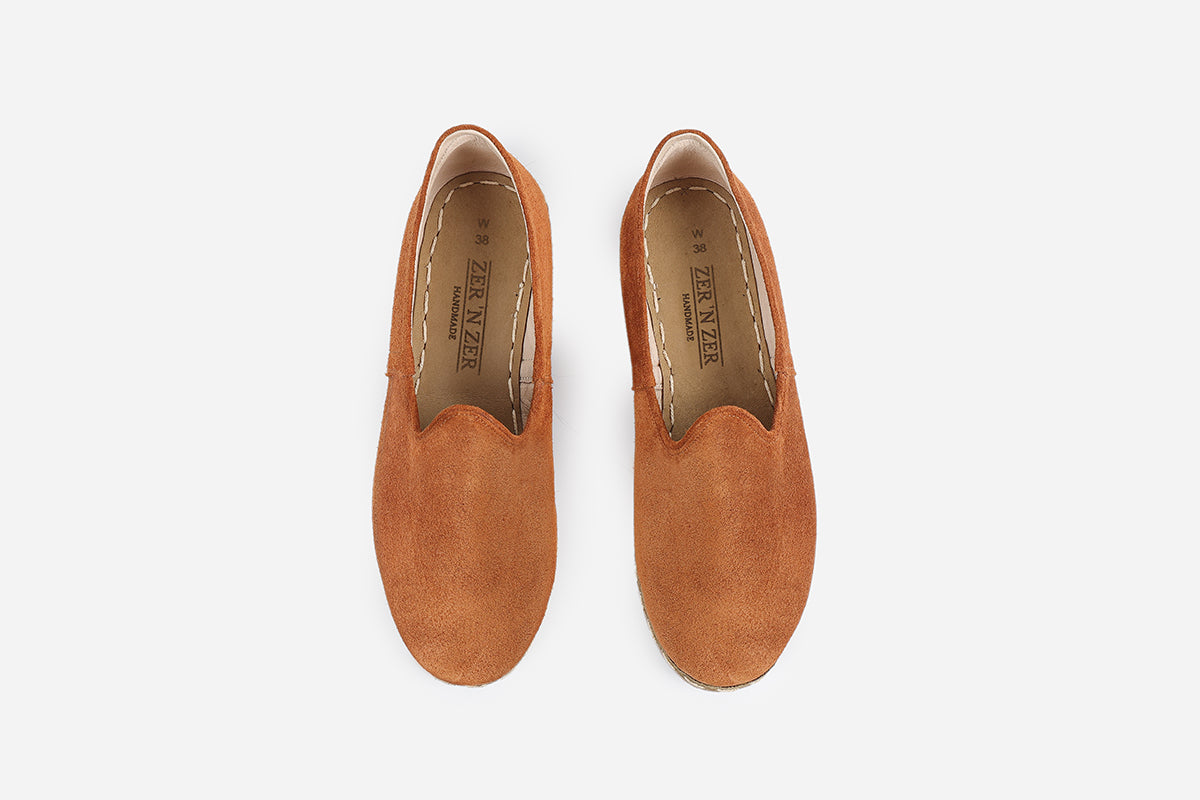 Chic Sunset Orange loafers for women, made from soft suede with a handmade finish and a bold, fiery tone.