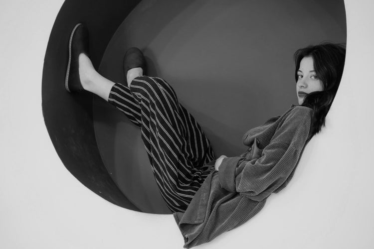 Woman laying with leather shoes